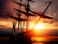 Old ancient pirate ship on peaceful ocean at sunset. Royalty Free Stock Photo