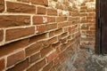 Old ancient red brick wall with cement mortar with egg. A resistant mortar keeps broken bricks Royalty Free Stock Photo