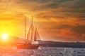 Old ancient ship on peaceful ocean at sunset. Calm waves reflection, sun setting. Copy space Royalty Free Stock Photo