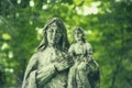 Old and ancient statue in the spiderweb: of the Virgin Mary with the baby Jesus Christ. Retro styled image Royalty Free Stock Photo