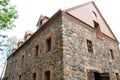 old ancient stone building. A cobblestone castle. Restoration of old buildings. Modern brick roof on an antique house Royalty Free Stock Photo