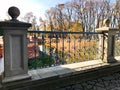 Old ancient vintage beautiful stone wrought iron railing of a bridge with patterns on the background of the river and trees Royalty Free Stock Photo