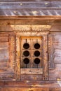 Old ancient wooden carved window with old wooden planks