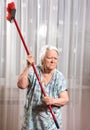 Old angry woman threatening with a broom Royalty Free Stock Photo