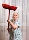 Old angry woman threatening with a broom