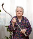 Old angry woman threatening with a cane Royalty Free Stock Photo