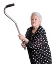 Old angry woman threatening with a cane Royalty Free Stock Photo