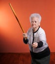 Old angry woman threatening with a rolling pin Royalty Free Stock Photo