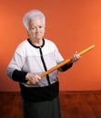 Old angry woman threatening with a rolling pin Royalty Free Stock Photo