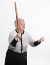 Old angry woman threatening with a rolling pin Royalty Free Stock Photo