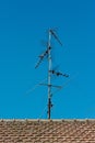 old antenna on a red roof for analog transmission and DTT Royalty Free Stock Photo