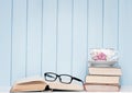 Old antiquarian books, glasses and china cup on the bookshelf Royalty Free Stock Photo