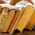 Old antiquarian books stand horizontally in a row. Front view. S Royalty Free Stock Photo
