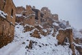 Old antique abandoned city Gamsutl in foggy snowy winter Caucasus mountains, Dagestan, Russia