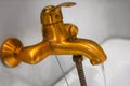 Old antique bath tap working, water flow, made of brass or copper Royalty Free Stock Photo