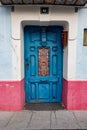 Old antique blue wooden door in a tenement house Royalty Free Stock Photo