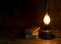 Old antique books with burning paraffin lamp. Royalty Free Stock Photo