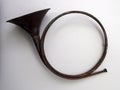 Old antique brass hunting horn white wall