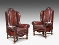 Antique leather wing chair carved legs isolated