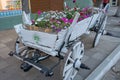 An old antique cart in white, filled with flowers