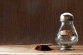 OLD ANTIQUE COFFEE BOTTLE WITH BRASS CAP AND A HEAP OF COFFEE GROUNDS ON A WOODEN BOARD Royalty Free Stock Photo