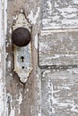 Old antique door knob and pealing white paint background Royalty Free Stock Photo