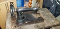 Old, antique and dusty metal mechanical sewing machine