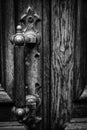 Old Antique Handle On Wooden Entrance Door. Handle On Wooden Door. Black And White Background. Royalty Free Stock Photo