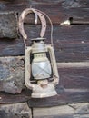 Old antique kerosene lantern lamp hanging on a wooden wall Royalty Free Stock Photo