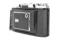 Old, antique pocket camera. The black camera is covered with a black leather handle. Front view on a white background Royalty Free Stock Photo