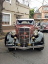 Old classic 1935 Ford 48 V8 coupe five windows flathead parked in the street.