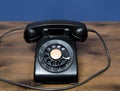 Antique old rotary dial telephone on wooden desk Royalty Free Stock Photo