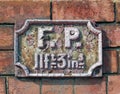 Old antique rusting british fire point sign used to indicate the distance to an available water supply