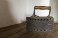 Old antique rusty iron on the wooden shelf