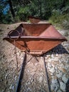 Old antique mine dump car and track in the wild