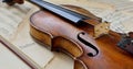 An old antique violin on a table with yellowed sheet music . Royalty Free Stock Photo