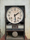 Old and antique wall clock that has been damaged.