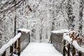 Old antique wooden foot bridge in a winter forest Royalty Free Stock Photo