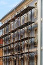 Old apartment building reconstruction with scaffolding on street facade side