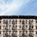 Old apartment buildings in the Lower East Side neighborhood of New York City with empty blue sky background Royalty Free Stock Photo