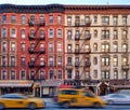 Old apartment buildings in the East Village neighborhood of New York City with taxis driving down the street Royalty Free Stock Photo