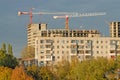 Old apartment house against construction crane Royalty Free Stock Photo