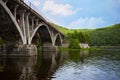 Old arch bridge over the river on a summer day Royalty Free Stock Photo