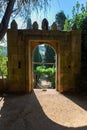Old arch gate, path and staircase in granite to vineyards and typically Mediterranean, inside the gardens at the Solar de Mateus Royalty Free Stock Photo