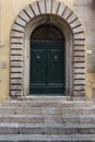 Old arched door with stone surround Royalty Free Stock Photo