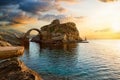 The old arched stone bridge leading to the ancient Castle of Andros island, Greece Royalty Free Stock Photo
