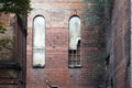 Old arched windows in a brick wall of an old destroyed building, background or concept Royalty Free Stock Photo