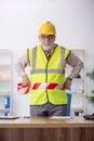 Old male architect holding caution tape Royalty Free Stock Photo