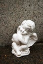 Little angel with heart figure on a grave. Memory of darlings.