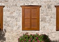 Old architecture with wood shutters on ancient window, stone wall Royalty Free Stock Photo